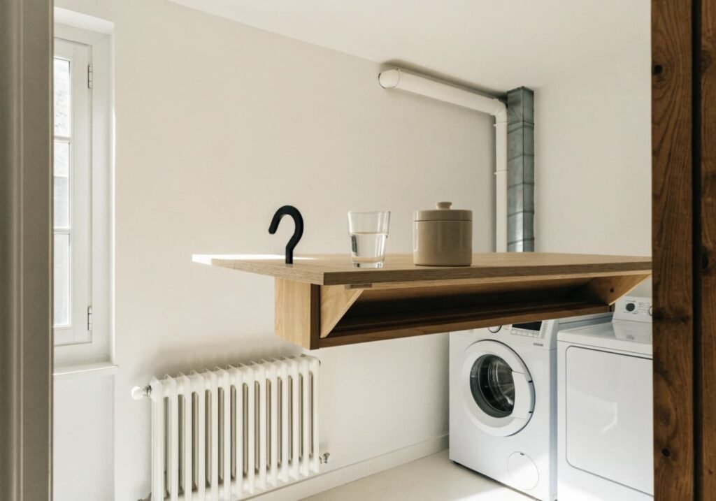 Minimalist floating folding table mounted on laundry room wall