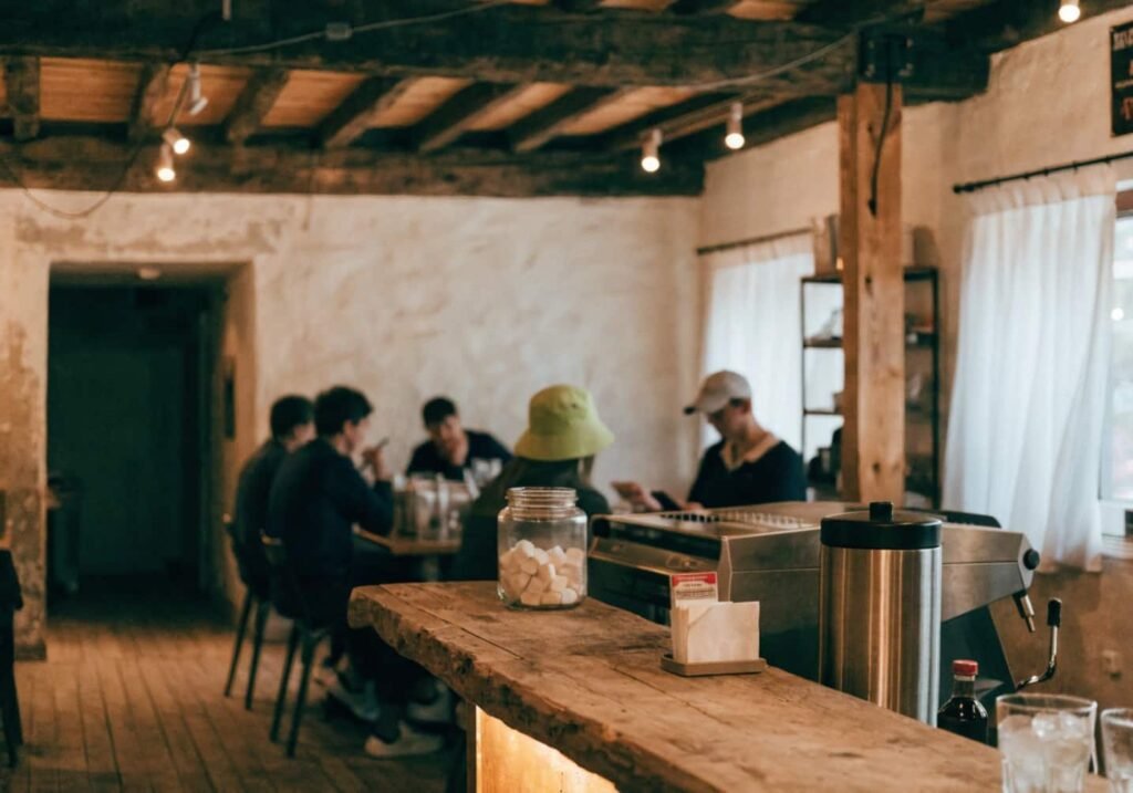 Warm wooden cafe interior with rustic beams and cozy natural lighting