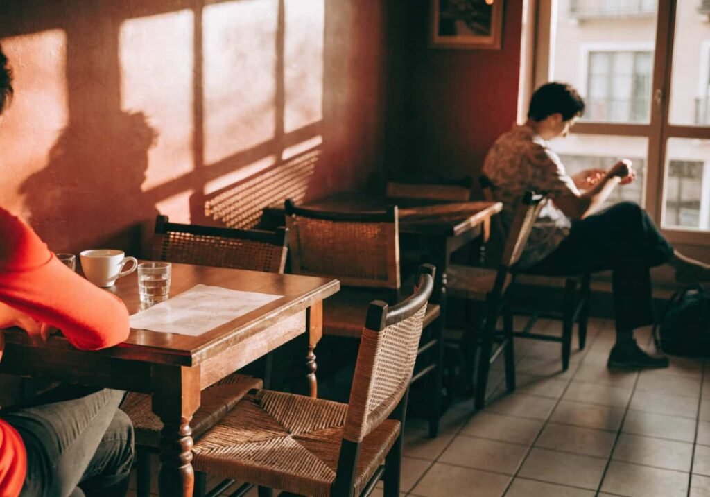 earthy terracotta cafe wall with rattan chairs and wooden tables