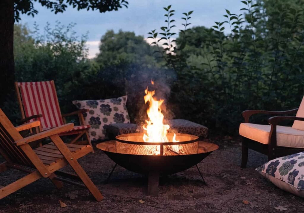 Backyard fire pit with seating arranged around it during evening hours