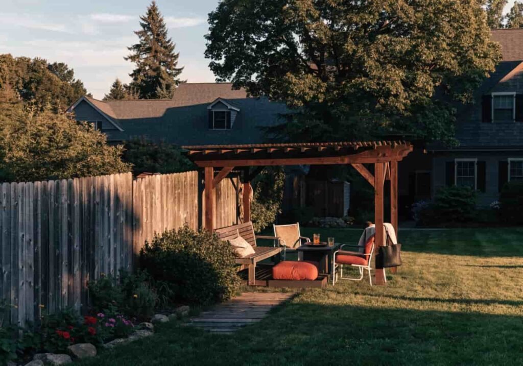 Backyard with a pergola and seating area in cozy evening light
