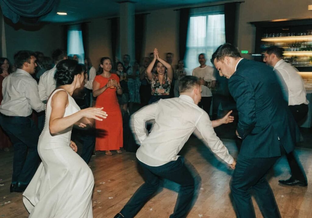 Wedding party performing a surprise dance routine as guests cheer