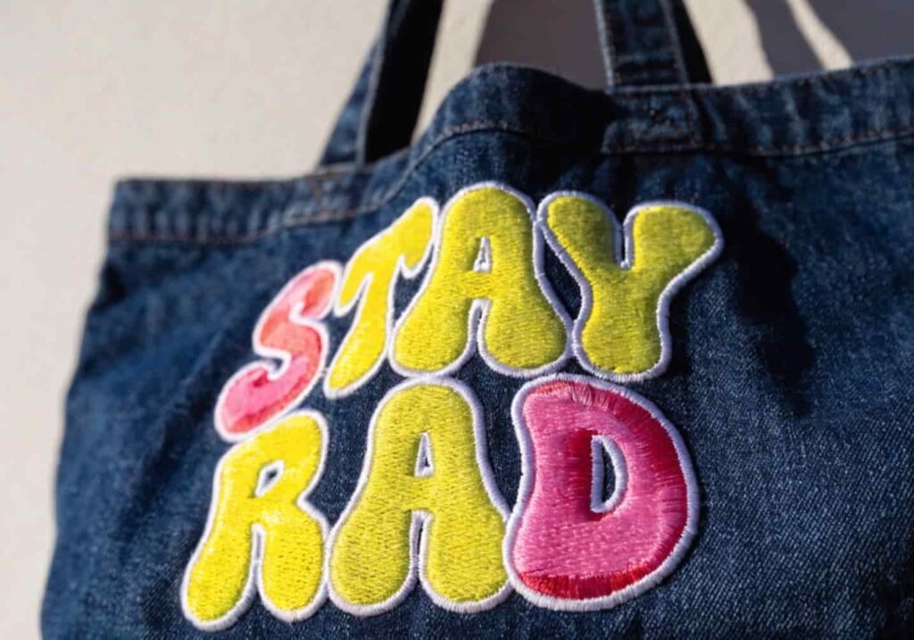 Denim tote bag with bold Y2K style bubble letter embroidery