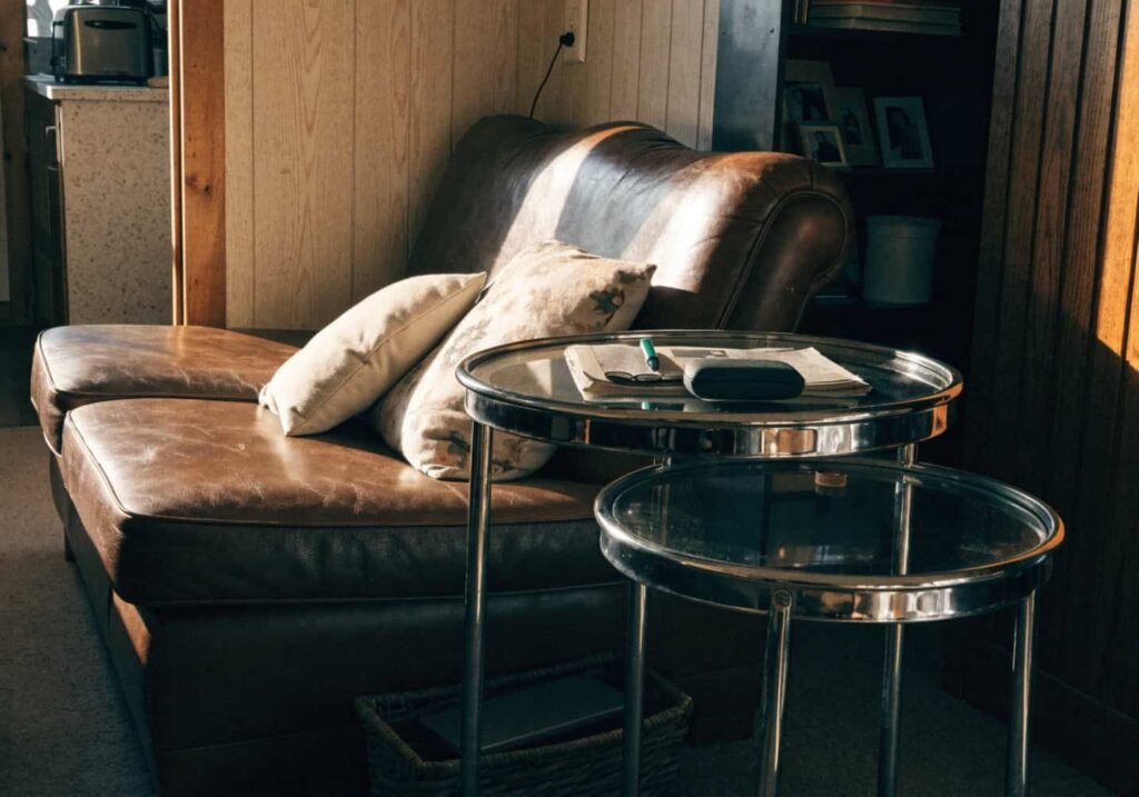 Compact chrome nesting side table beside a loveseat in a small cozy living room