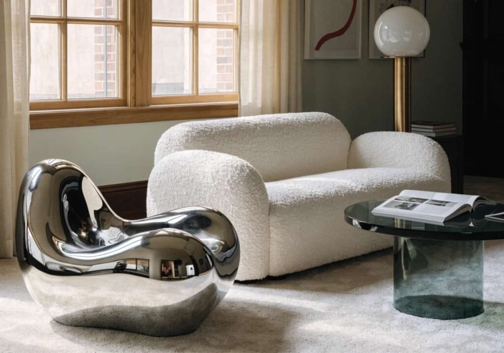 Liquid metal chrome accent chair in a modern living room setting