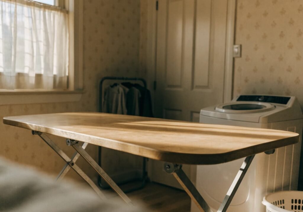 Curved-edge folding table in soft modern laundry room design