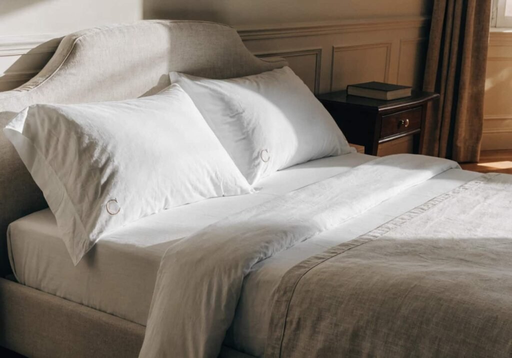 Monogrammed pillowcase with embroidered initial on a neatly made bed