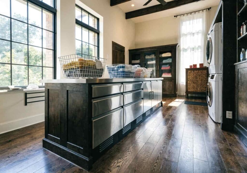 Matching millwork connecting a kitchen and laundry folding station
