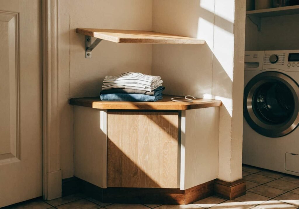 Corner folding nook built into a tight laundry room space