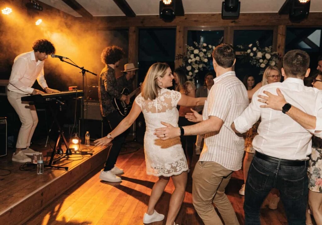 Live band performing while guests dance at a wedding reception