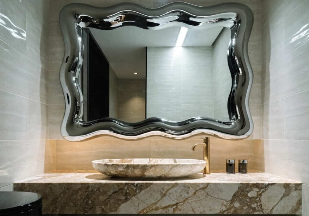 Liquid metal chrome bathroom decor idea with wavy mirror frame