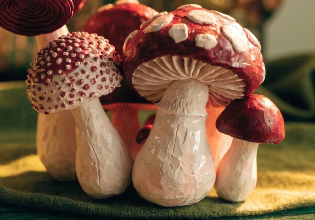 Group of handmade clay mushroom figures with white dotted caps