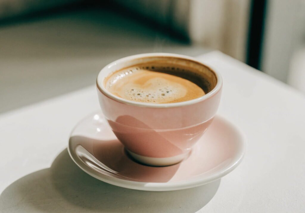 Pink and cream coffee cup aesthetic close-up shot with soft natural light