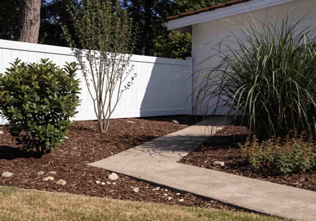 Low-maintenance yard landscaping with native plants and mulch