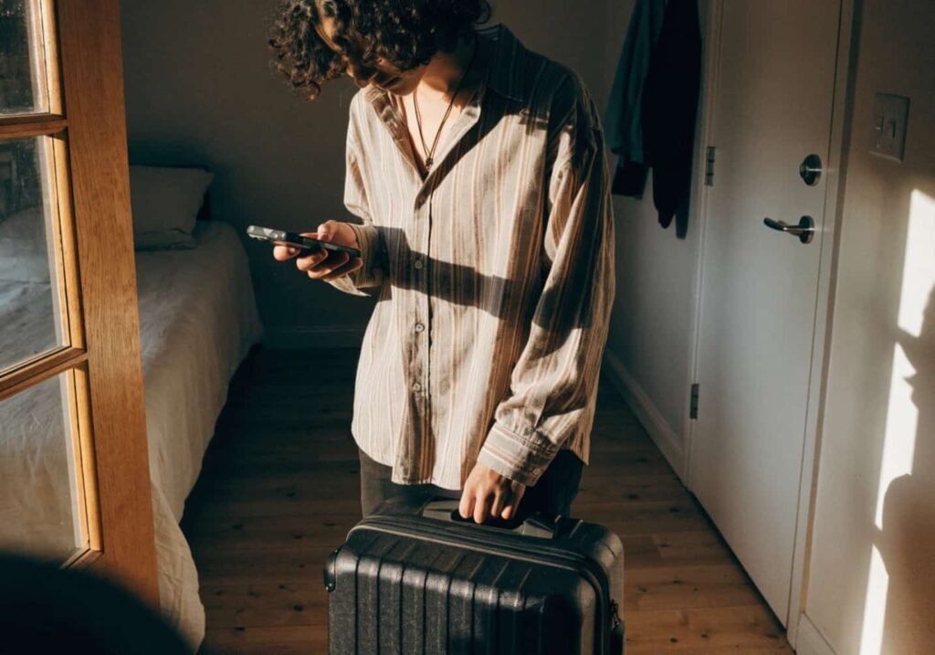 Person zipping suitcase and checking travel documents before leaving for a trip
