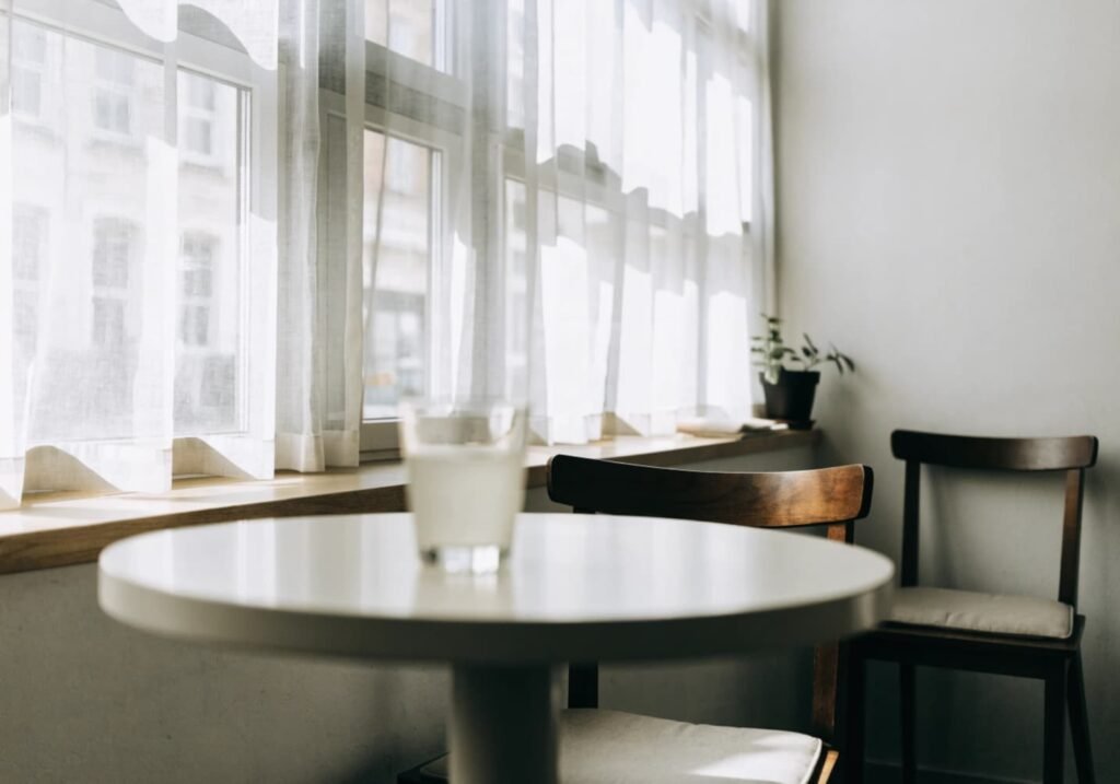 Light and airy cafe corner with big window and soft natural light