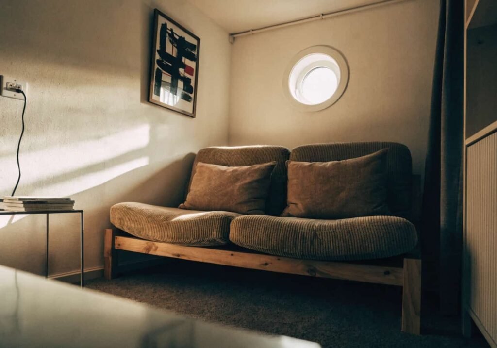 Small living room with sofa tucked into the corner to save floor space