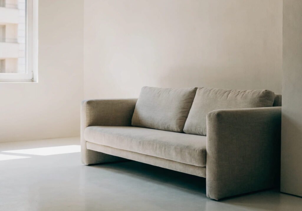 Minimalist beige sofa in a clean, clutter-free modern living room
