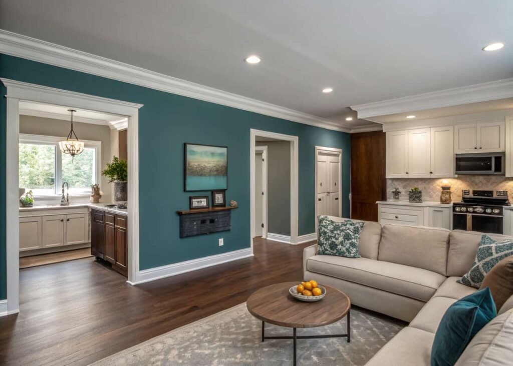 Wall color contrast used to define living room and kitchen zones