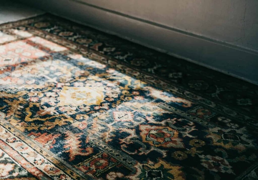 Vintage woven textile against a gray wall showing boho design roots