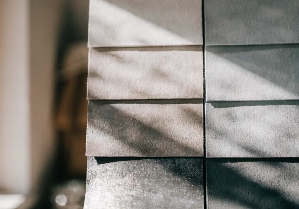 Warm grey and cool grey fabric swatches compared in daylight