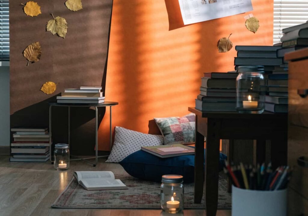 Fall-themed kindergarten reading corner with warm lighting and autumn leaf decorations.