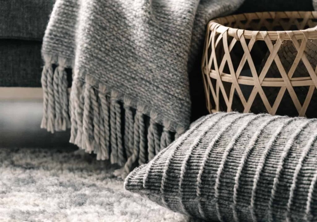 Layered textures on grey sofa in boho living room