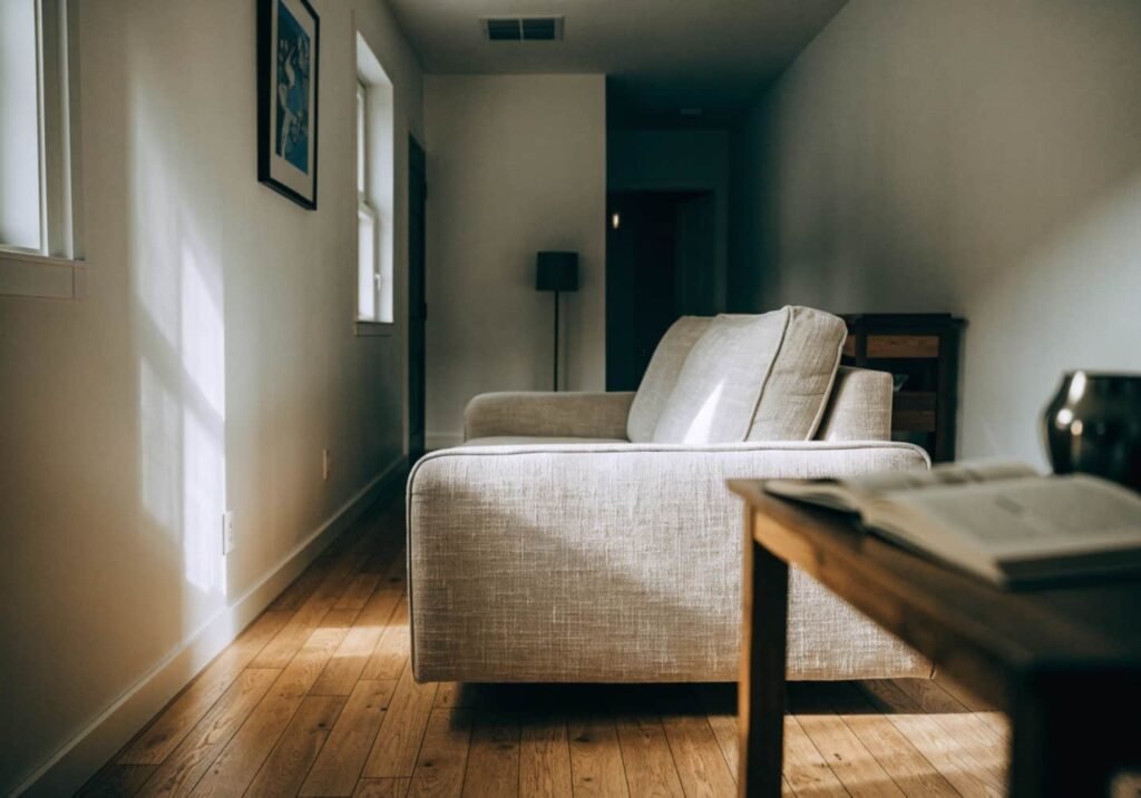 Slim-arm sofa design maximizing walking space in a narrow living room.
