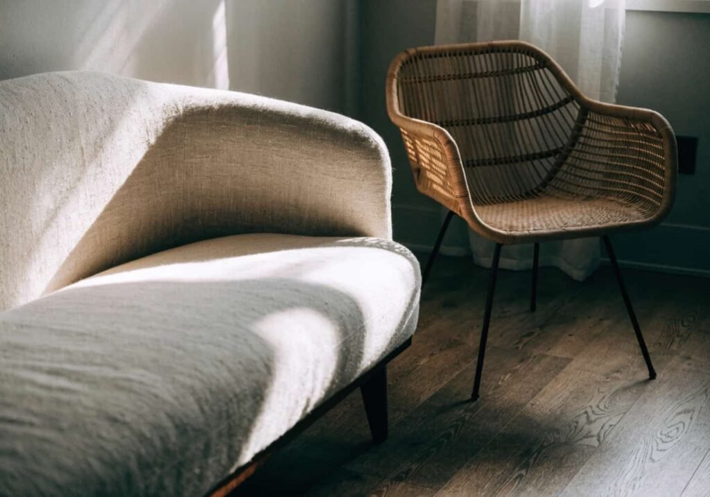 Rattan chair and linen sofa in a gray boho living room