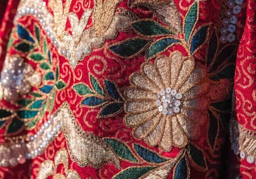 Red and gold traditional wedding fabric representing cultural color symbolism.