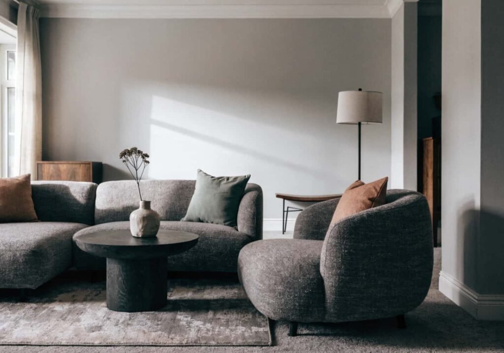 Calming terracotta and sage accent colors in a gray boho living room