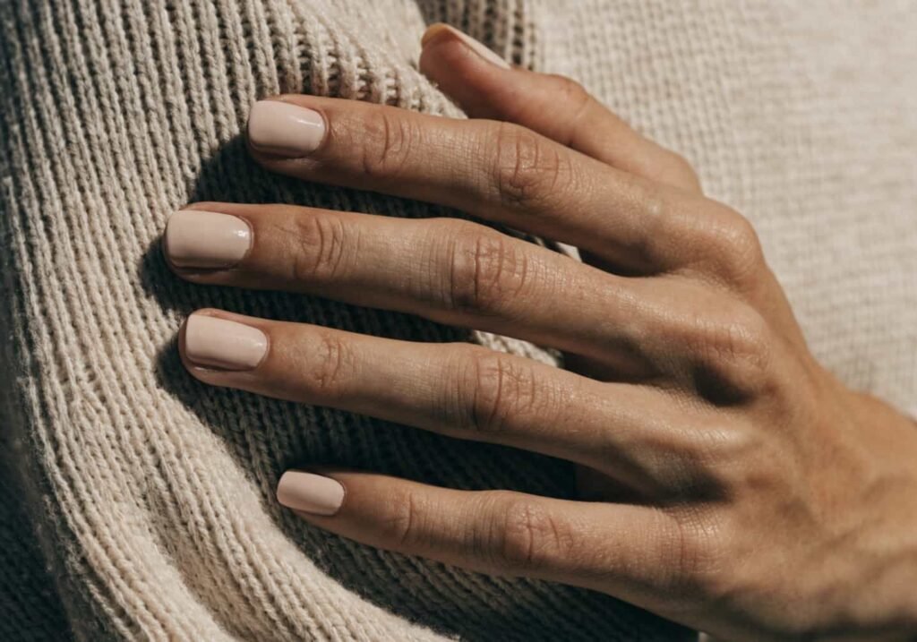 Short squoval nail shape in neutral polish demonstrating minimalist nail styling