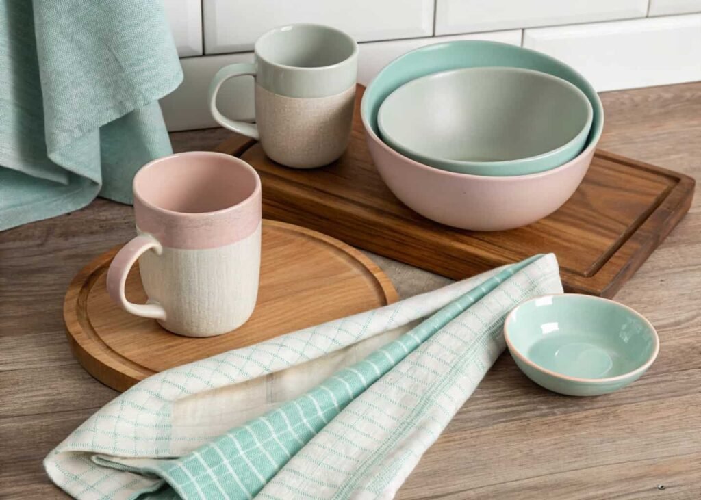 Kitchen accent color palette shown through mugs, towel, and bowl on countertop