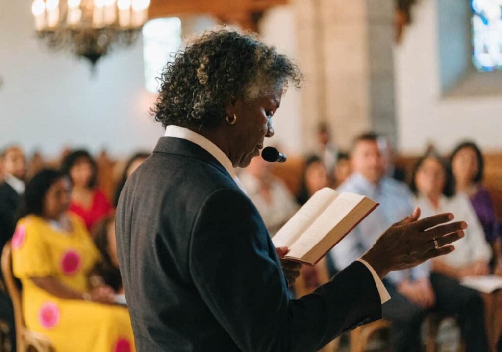 Officiant wearing a lavalier microphone during indoor wedding ceremony
