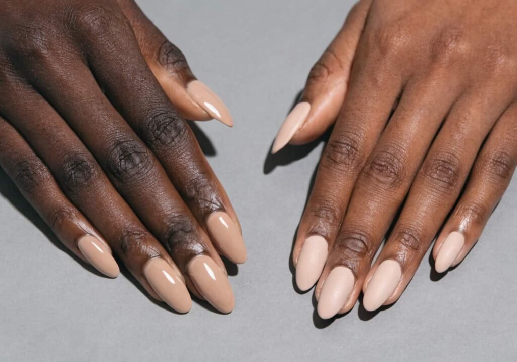 Side-by-side comparison of a glossy finish manicure and a matte finish manicure in the same nude shade