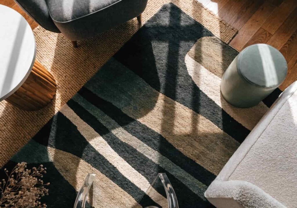 Layered jute and patterned rugs in a gray boho living room