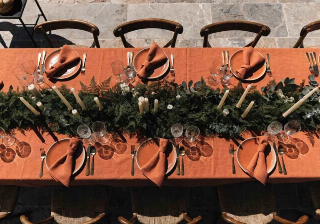 A wedding table decor setup coordinating gold metallics with terracotta and cream tones.