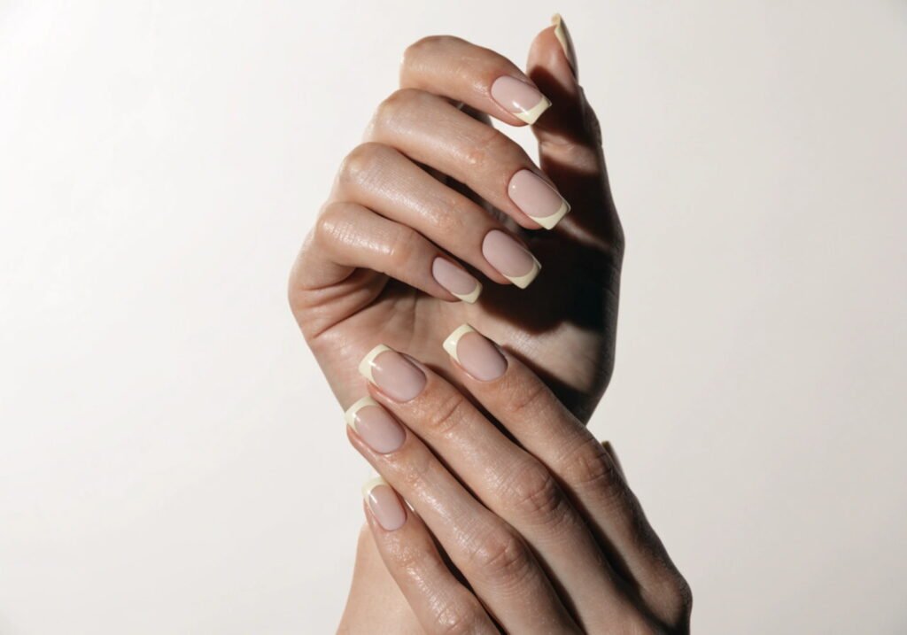 Modern classy French manicure with thin cream tip line