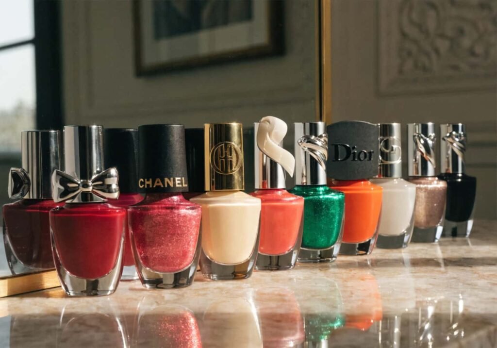 Collection of high-end luxury nail polish bottles on a vanity table