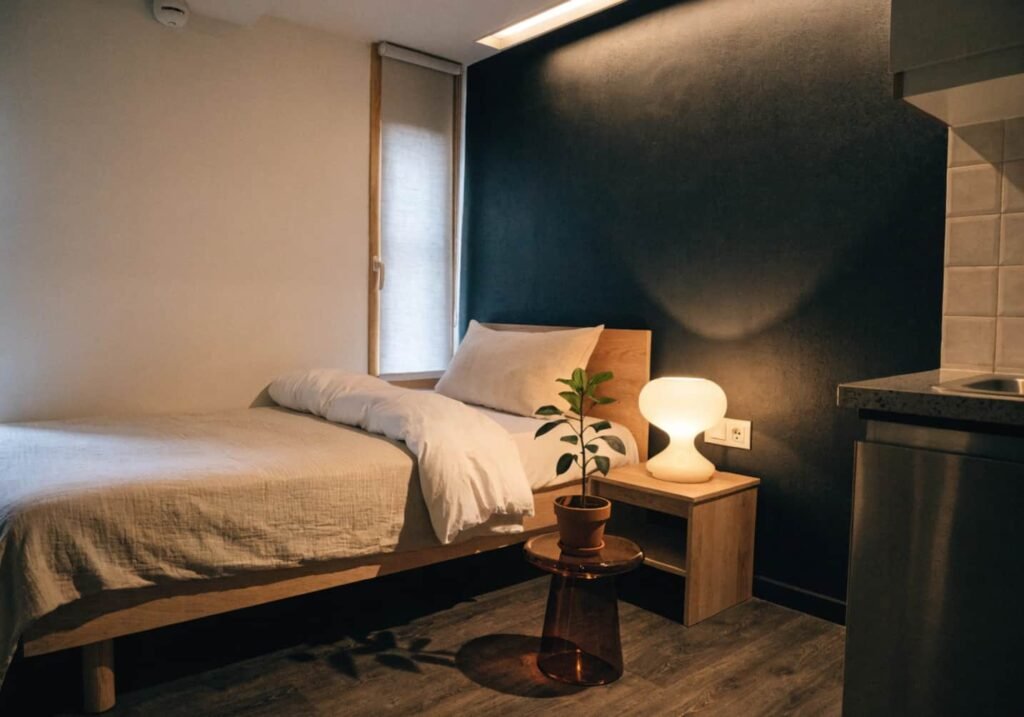 Small studio apartment styled with an intentional black accent wall