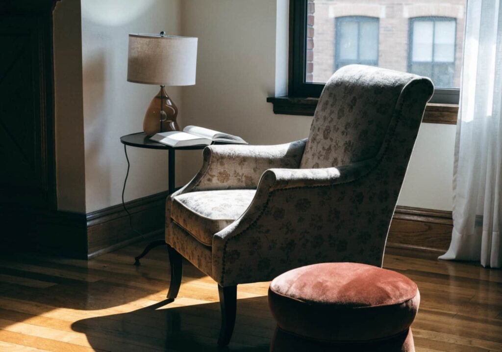Cozy reading corner with armchair positioned near natural light
