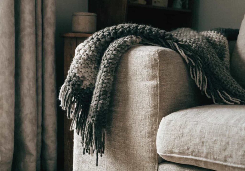 Handmade crochet throw blanket on a living room sofa