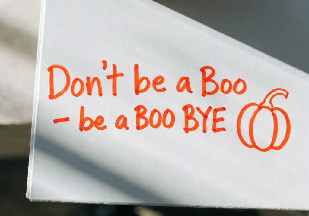 Short Halloween pun handwritten in orange marker on a white board next to a pumpkin doodle.