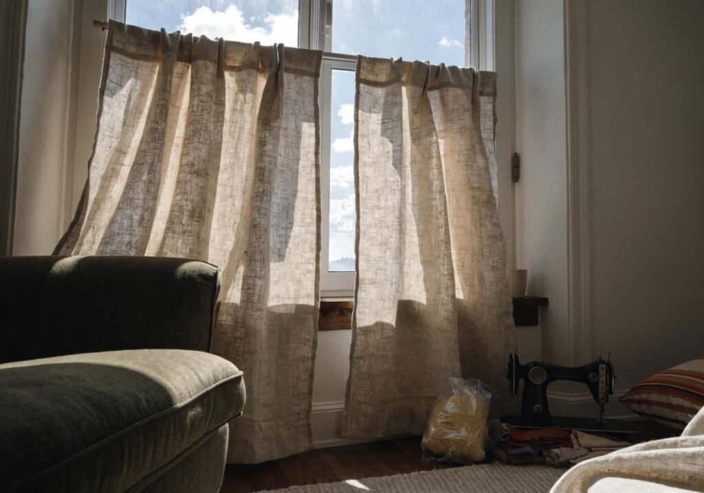 DIY sewn linen curtains hanging in a living room window