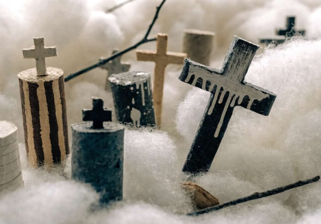DIY miniature graveyard craft made from recycled toilet paper roll tombstones.