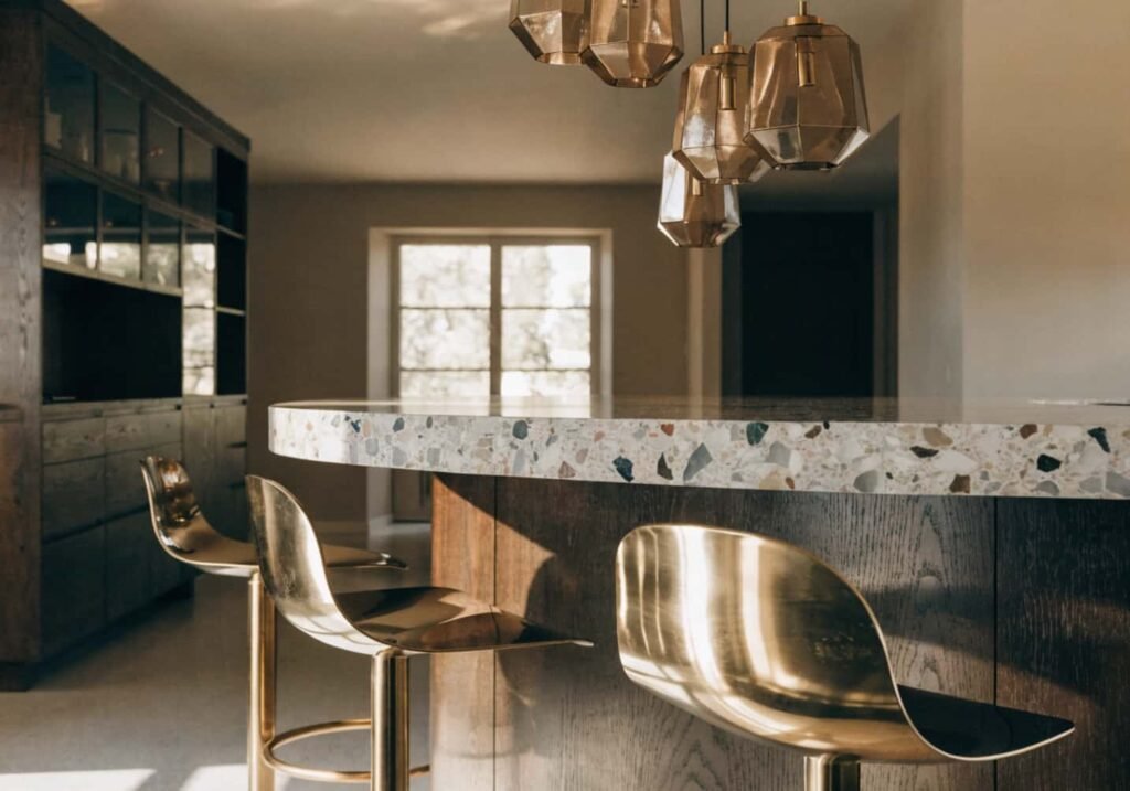 Neo Art Deco kitchen island with terrazzo countertop and brass pendant lighting trend 2026