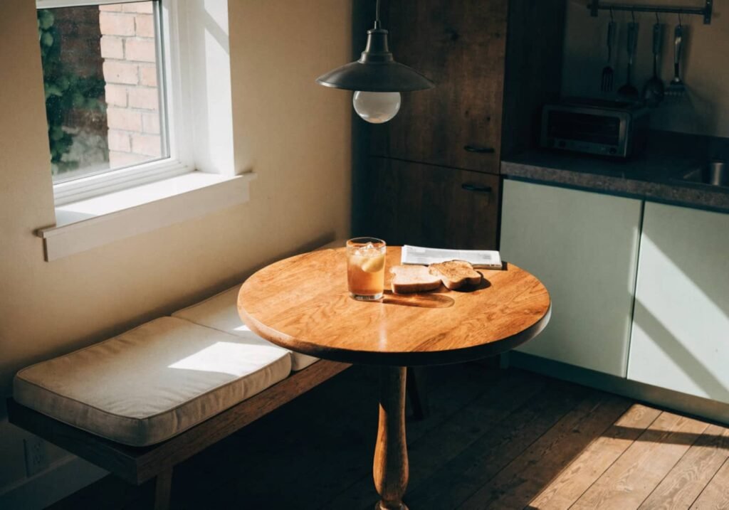 Cozy kitchen nook with cushioned bench seating near a window
