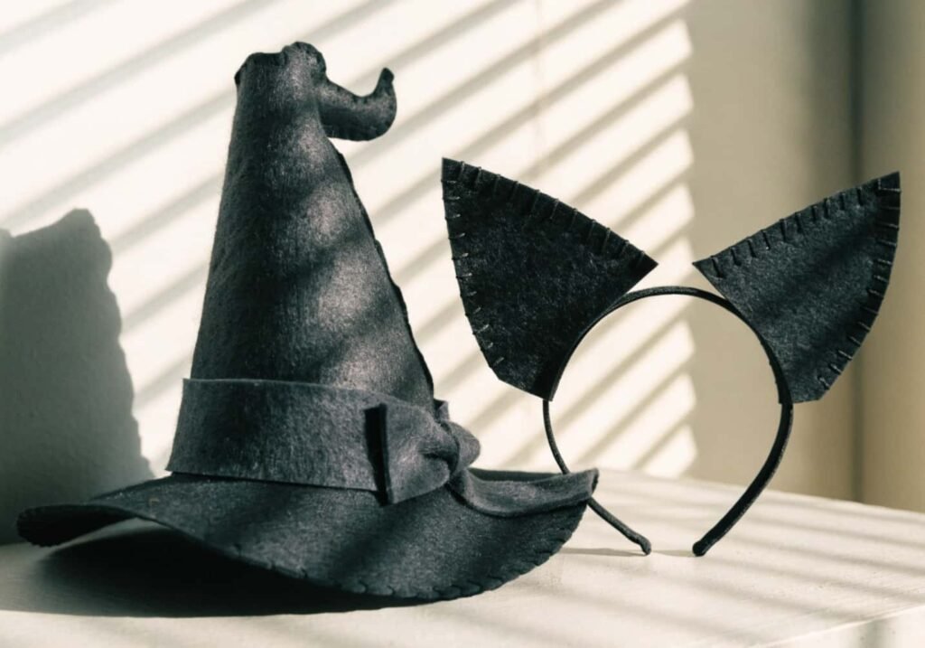 DIY Halloween costume accessories including a craft foam witch hat and felt cat ears.