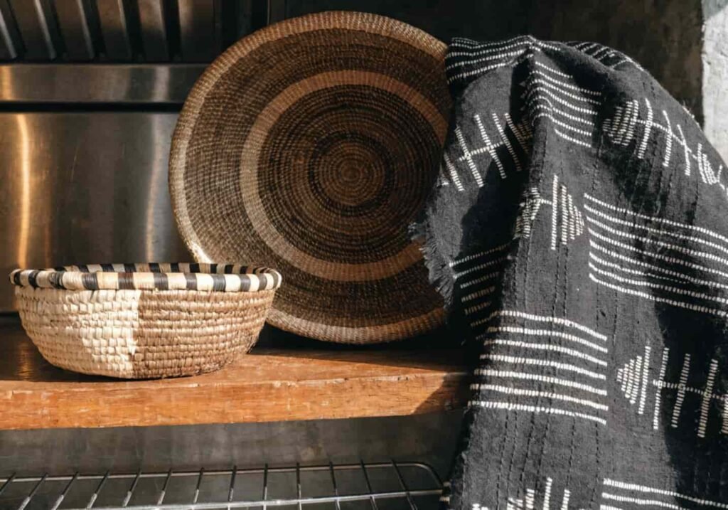 Handwoven baskets and mudcloth fabric showing the heritage behind Afrohemian style