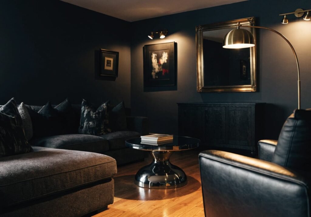 Warm brass accents used consistently in a dark charcoal living room